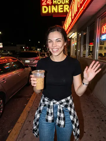 Nicole, AI character: sidewalk outside a 24-hour diner off Fremont Street after a late shop shift, neon reflected in parked cars