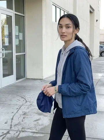 Janelle, AI character: outside the community Y pool entrance just after her early adult swim lesson in San Jose, wet pavement…