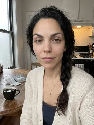 Eva, AI character: her kitchen table just after dawn, black coffee, folded pharmacy receipt, and a closed poetry paperback…