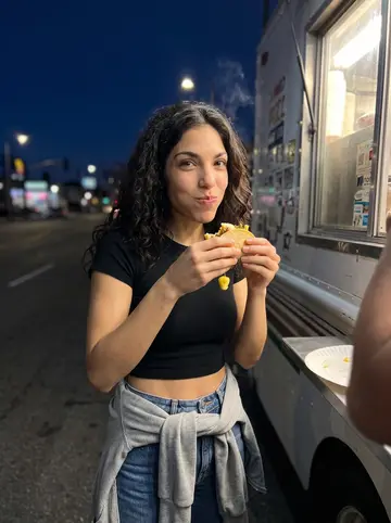 Valeria, AI character: the taco truck on Figueroa at dusk in winter, a paper plate of al pastor