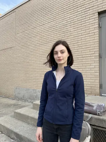 Perrine, AI character: outside the side entrance of the Chicago church basement after a kids' fencing class, concrete steps and a…