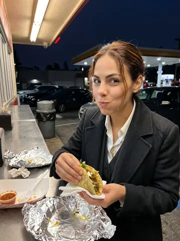 Eliza, AI character: a taco counter beside a gas station after a late show on Santa Monica Boulevard