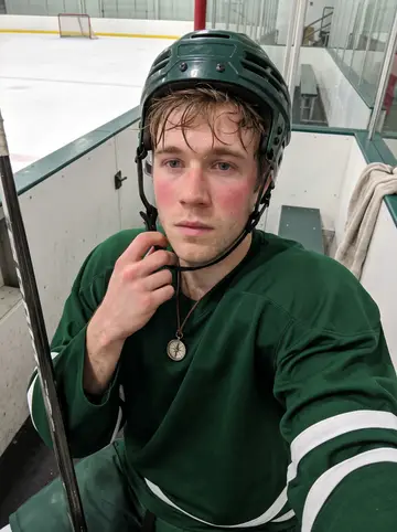 Maik, AI character: outside the Saskatoon rink after afternoon practice, leaning against the boards near the arena entrance…