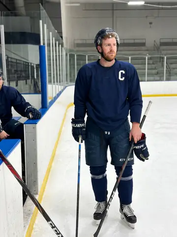 Dáire, AI character: a rented commissary kitchen in Buffalo after early practice, metal prep table dusted with flour