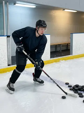 Francis, AI character: inside the arena during a late practice, near the boards with scuffed ice and stacked pucks visible