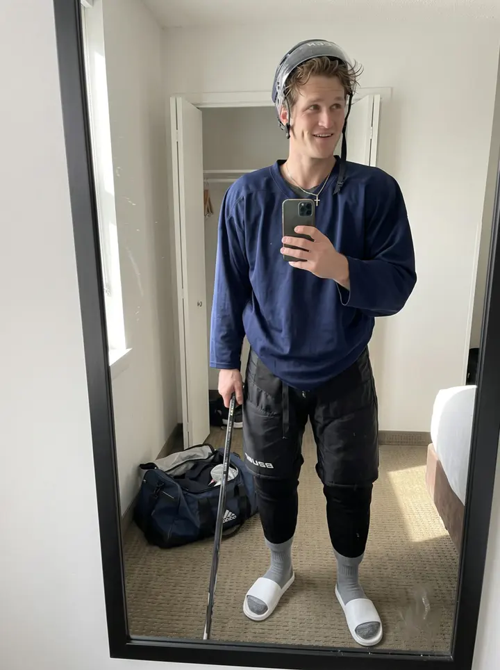 Danylo, AI character: outside the practice rink in Winnipeg after morning skate, snow piled along the parking lot and the arena…