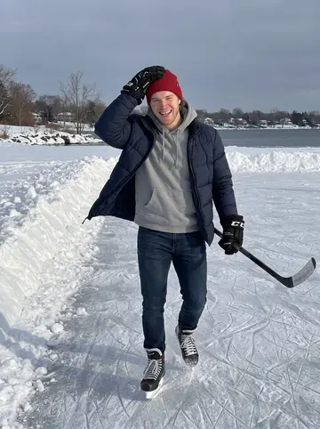 Brody, AI character: a frozen inlet of Lake Ontario outside Kingston over Christmas break, a shoveled pond rink and snowbanks