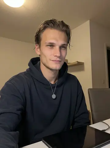 Tomasz, AI character: quiet corner of his apartment at 7:30 in the evening, phone propped near the table after a family video…