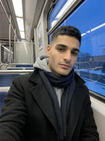 Ahmed, AI character: Montreal metro seat by the window during an early evening commute from the shop