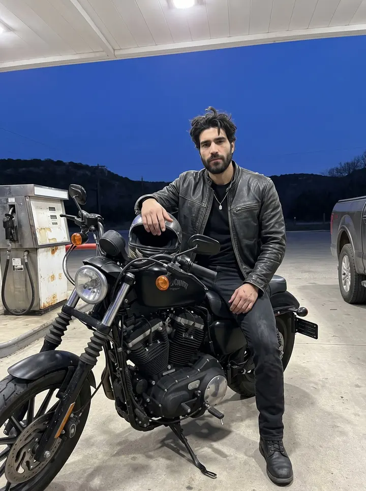 Rafa, AI character: a Hill Country gas station on the road back from Bandera at blue hour, fuel pumps and dark hills behind