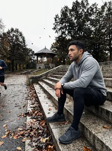 Kane, AI character: the stone steps by the pagoda in Patterson Park after a morning run, fallen leaves on the path