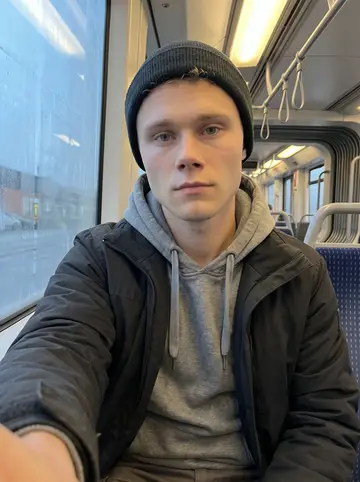 Mees, AI character: inside a quiet early tram toward the warehouse district, fogged Rotterdam windows behind him