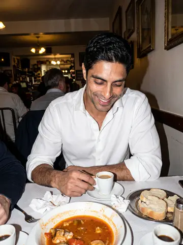 Estêvão, AI character: a small Portuguese social club in New Bedford during a winter dinner, bowls of caldeirada and small cups…