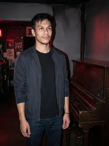 Cole, AI character: small East Austin listening bar with a battered upright piano near the back wall