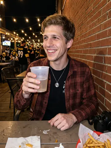 Mark, AI character: a Steelers Sunday bar patio in Pittsburgh, camera resting on the table beside a plastic basket of fries
