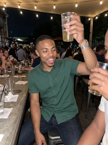 LaMarcus, AI character: crowded patio bar near the BeltLine with cousins after a wedding-planning dinner