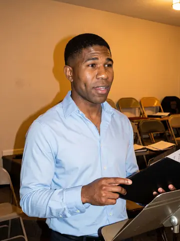 Jahmal, AI character: small church fellowship hall two blocks from his apartment after choir rehearsal, folding chairs and music…