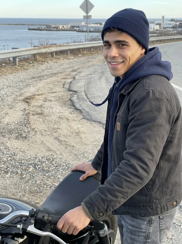 Jonathan, AI character: a windy overlook on the coast road above the cold harbor, beside his secondhand black motorcycle with the…