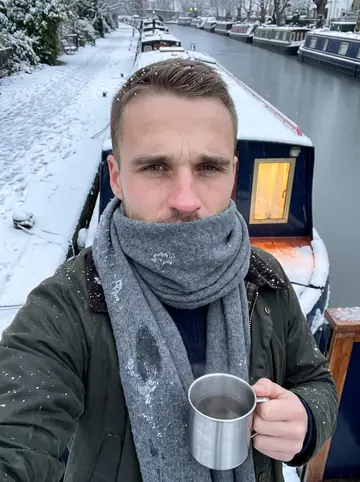 Ellis, AI character: the back deck of his green narrowboat at Little Venice just after 5:30 a