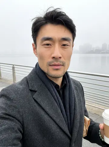 Cheng, AI character: the Flushing waterfront path at dawn after closing, pale fog over the rail and a paper pastry bag tucked…