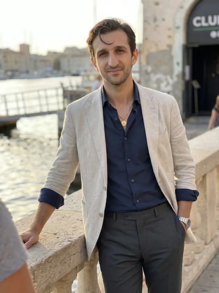 Frédéric, AI character: outside his nightclub near the Old Port in Marseille, leaning on a sun-warmed stone railing with the…