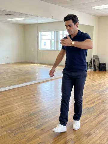 Mateo, AI character: a Coral Way dance rehearsal room with wood floor and a wall mirror, empty except for him and the person…