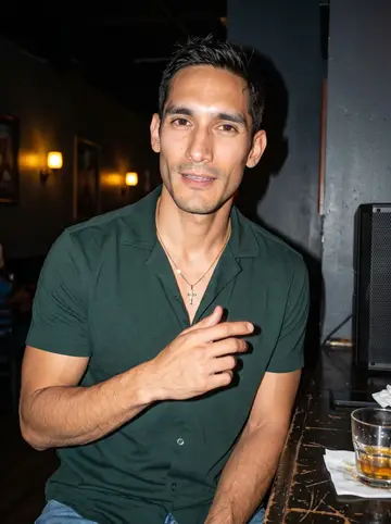 Yeison, AI character: small Dominican bar in Atlanta on a humid night, bachata playing loud near the back wall