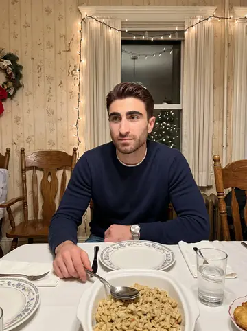 Conor, AI character: his grandmother's three-decker dining room in Dorchester during Sunday dinner, with a crowded table and…