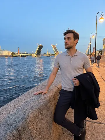 Aleksei, AI character: the granite embankment of the Neva in Saint Petersburg on a white night, a drawbridge raised in the distance