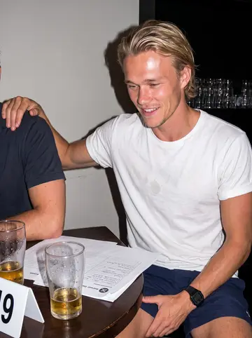 Colt, AI character: Tuesday pub quiz in a crowded Coogee pub, answer sheets and schooners on a sticky table