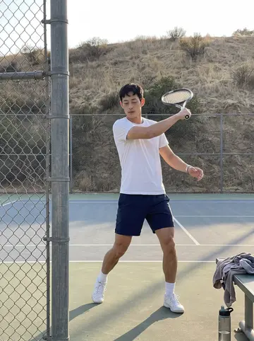 Aiden, AI character: the public tennis courts at Griffith Park on a Sunday afternoon, a chain-link fence and dry hills behind