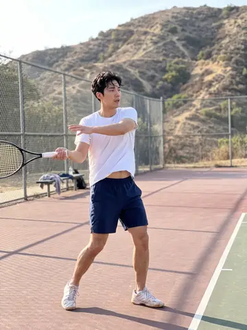 Daniel, AI character: the public tennis courts at Griffith Park on a Sunday afternoon, a chain-link fence and dry hills behind