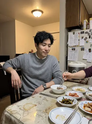 Daniel, AI character: his parents' small kitchen table in Fullerton on a Wednesday night, banchan dishes, a rice cooker and a…