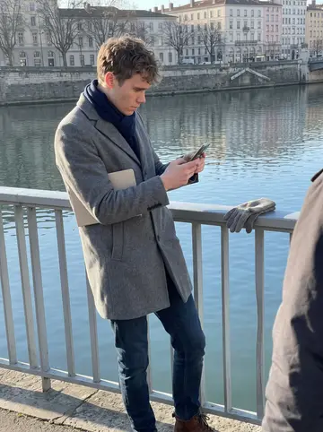 Jean-Baptiste, AI character: a railing above the Saône on a clear winter afternoon, one lost wool glove caught on the metal bar