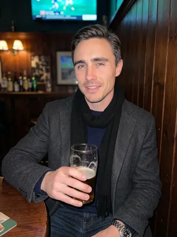 Matthew, AI character: a small Dublin pub near Fenway showing an old hurling match on a TV behind the bar