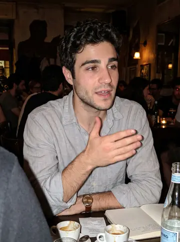 Alan, AI character: a small bar off Via Po after a trainee-lawyer study group, crowded table with empty espresso cups and…