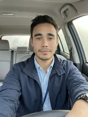 Ricardo, AI character: parked in his compact car before a property inspection, windshield fogged at the edges