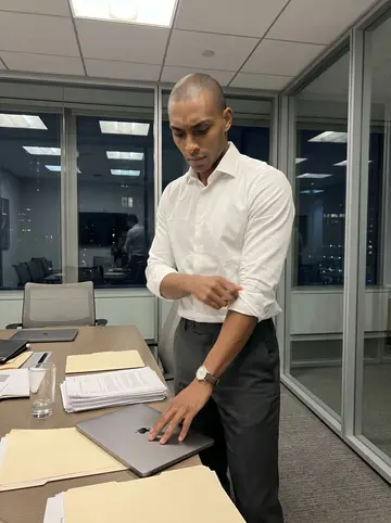 Femi, AI character: a Manhattan office conference room after most people have gone home, glass wall and dark city windows…
