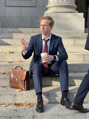 Prescott, AI character: stone steps outside a Baltimore city courthouse downtown, fallen leaves on the steps