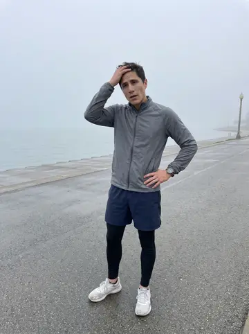 Morgan, AI character: the lakefront running path before sunrise, with fog sitting low over Lake Michigan