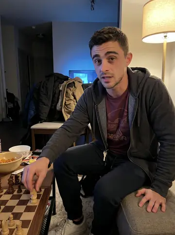 Kobe, AI character: a friend's apartment game night in Austin, chess board and snack bowls on a low table, coats piled on a chair