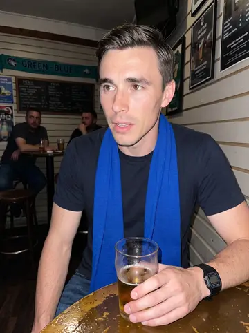 Jarosław, AI character: a small Polish bar in Avondale during a Lech Poznań match, crowded tables and green-blue scarves behind him
