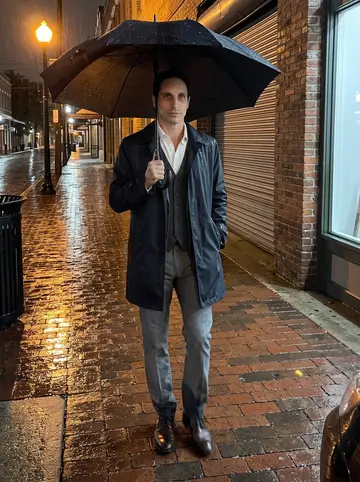 Mario, AI character: old cigar-factory streets of Ybor after midnight, wet brick sidewalk and closed storefronts around him