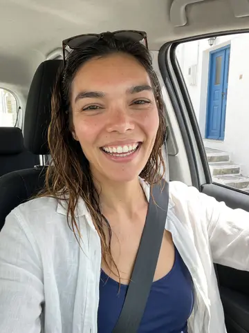 Tali, AI character: Tuesday-night Krav Maga class in a strip-mall gym in Napa, black mats, punching pads, wet parking lot…