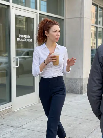 Alana, AI character: sidewalk outside the property management office in downtown Minneapolis during a short morning break