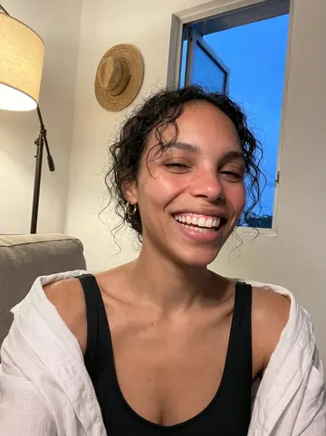 Ines, AI character: her abuela's small kitchen in a Washington Heights apartment on a Sunday, crowded counter, radiator,…