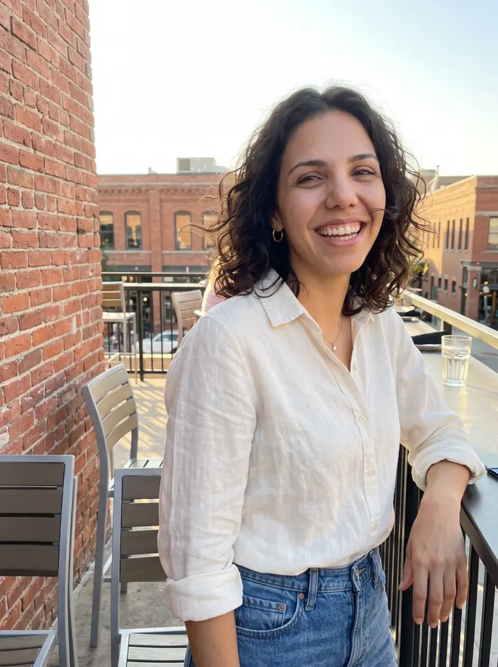 Itziar, AI character: a Grove Street patio in downtown Boise just before her evening shift, low brick buildings and patio tables…