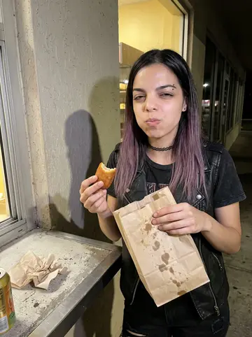 Mayelin, AI character: outside a Hialeah window bakery at 3 a