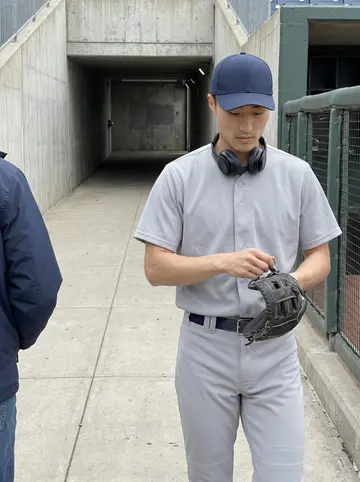 Yuchen, AI character: team bus seat on the ride back from an away game, dark highway window beside him