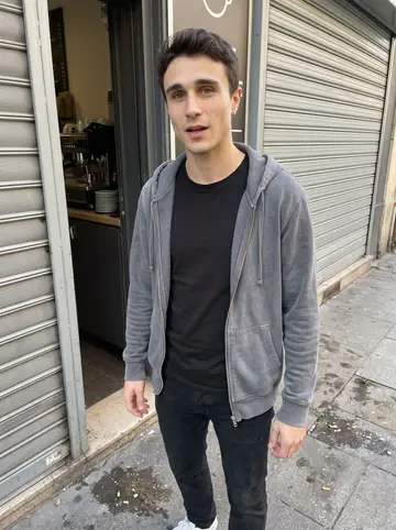 Joris, AI character: outside a narrow espresso counter near the port where he stops before work, metal shutters half-open…